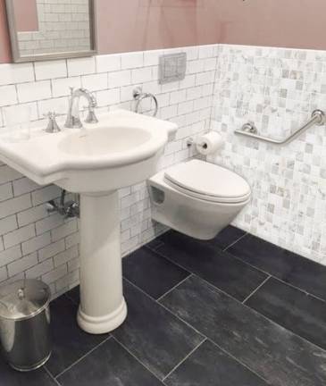 Slip-resistant tile and well-placed grab bars can reduce seniors' risk of falling in the bathroom, and wall-mounted toilets can create additional space to maneuver walkers or wheelchairs. Image: Brower &amp; Russo Interior Design
