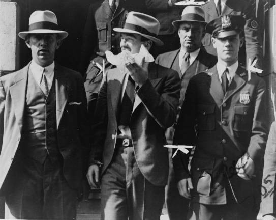 Vincent &#x201c;Mad Dog&#x201d; Coll (second from left) leaving court in 1931, surrounded by policemen. Photo: Library of Congress