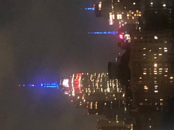 The Empire State Building started the night bathed in green light but switched to a red white and blue strobe light after the Rangers double OT win versus the Hurricanes in Game 2 of their series. Photo: Keith J. Kelly