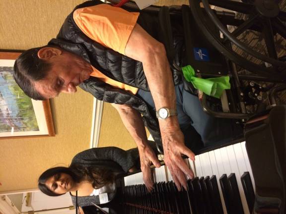 FiveStar resident at piano with an occupational therapist. Photo: Genia Gould