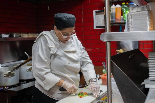 Nupur Arora uses the kitchen space at her husband's restaurant, Mughlai to cook her meal kits. Here she's seen chopping bell peppers. Photo: Priyanka Rajput