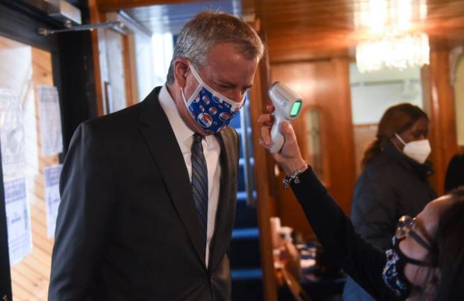 Mayor Bill de Blasio gets a temperature check before delivering remarks at the Iglesia El Camino Church in Brooklyn on Sunday, Nov. 15. Photo: Michael Appleton/Mayoral Photography Office