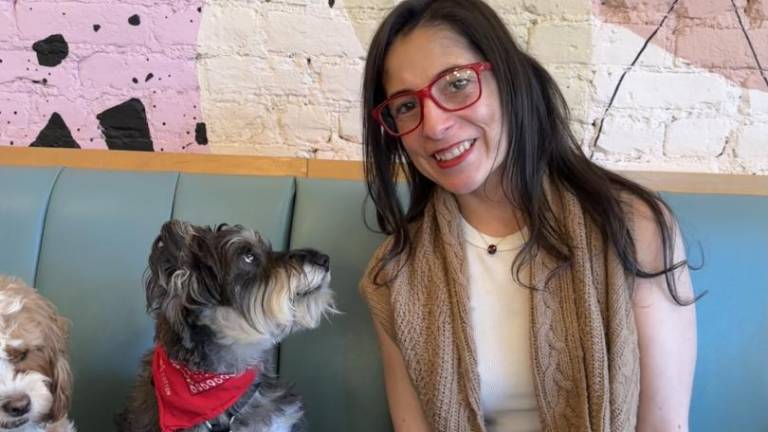 <b>Valerie Cortes and her puppy Goose love the cafe and believe in supporting local businesses, especially Boris &amp; Horton, the city’s first dog cafe.</b>