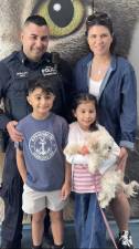 Hudson a two year old Maltese who was rescued from the East River by the NYPD Harbor was adopted by the DeSalvo family including Jared DeSalvo (left rear), his wife Nicole and their two children Salvatore (front left) and Stella. NYPD Officer DeSalvo was one of the cops who rescued Hudson on March 30.