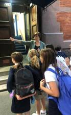 Epiphany principal Kate McHugh, following in the footsteps of her predecessor Jim Hayes, greets students at the door on their way into the lower school on East 22nd St. every school day. Photo: Keith J. Kelly