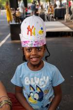 Young attendee wears the craft project she created at the Museum Mile Festival on Fifth Avenue.