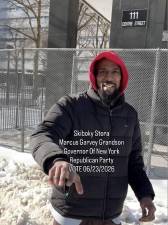 Aspiring politician Skiboky Stora poses for selife outside 111 Centre St. during his trial.