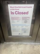 Sign at the front door of the once bustling front entrance to Mount Sinai Beth Israel Hospital, which shut down on April 9.