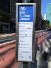 Bus sign indicates how to find out arrival times. Photo: Meredith Kurz