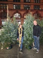 Heather Neville (with lights) says she places her Christmas tree orders in June. Her husband Dave, who is a roofer by trade, has time to assist her when bad weather slows down construction jobs in winter. Photo: Courtesy of Heather Neville
