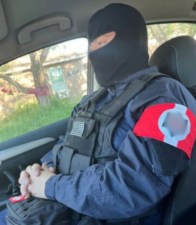 A photo that reportedly depicts Hayden Espinosa wearing a blurred-out swastika arm patch. Espinoza, a right-wing extremist, has been indicted for selling weaponry to an undercover cop– from federal prison.