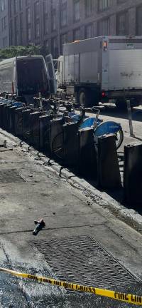 The ashen remains of a Citibike bike rack were started by a trash fire around 4 a.m.