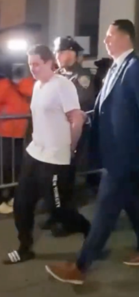Suspect John Woeltz is escorted by detectives after his arrest. He, along with William Duplessie, allegedly tortured an Italian tourist for three weeks in a bid to obtain his crypto wallet password.