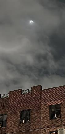 The partial eclipse as seen from 23rd Street between 8th and 9th avenues.