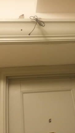 Wires and a hole that were used by one of five surveillance cameras removed by attorney Arthur Schwartz.