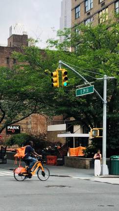 This e-biker, seen running a red light on First Avenue at 29th Street, could be targeted as a Quality of LIfe pilot program kicks off in six commands, including the 13th Precinct on the East Side of Manhattan.