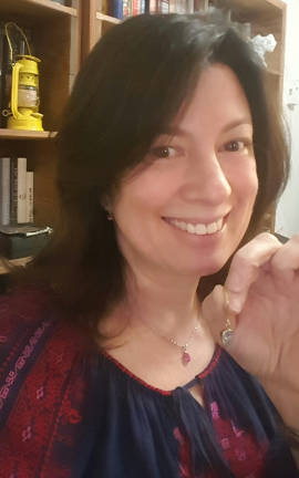 Retired NYPD Sgt. Robin Sternberg holds the 18-carat gold earring she found on a Second Avenue sidewalk after the St. Patrick&#x2019;s Day Parade on March 17. Photo: Robin Sternberg