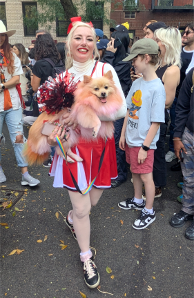 Cheerleader with pom pom dog at the 2025 Tompkins Square Halloween Dog Parade.