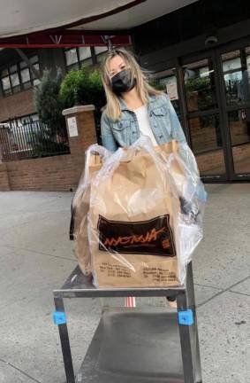 Victoria Lee making a delivery from Nyonya restaurant on Grand Street.