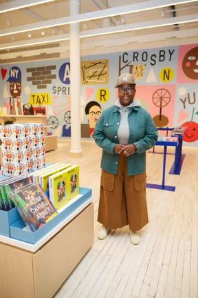 The artist, Nina Chanel Abney, in front of her mural, <i>LOVE NYC</i>, for the new MoMa Design Store.