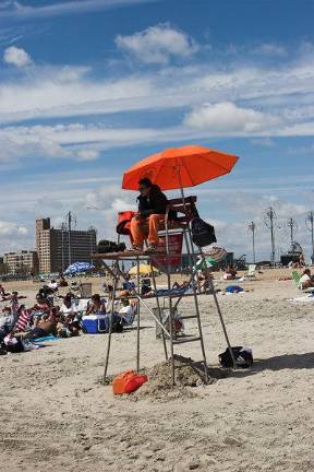 Lifeguards such as this one on Coney Island will not be manning the lifeguard stands on Wednesday Aug. 20 and Thursday Aug. 21 but will be patrolling the shores to make sure nobody goes in the water in any city ocean beaches due to dangerous rip tides created by Hurricane Erin.