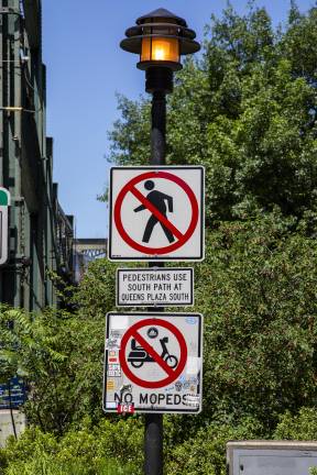 Signs on Queensboro Bridge in Long Island City. A clear prohibition of mopeds and separation between bike and pedestrian lanes.