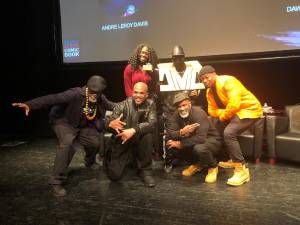 Andre Leroy Davis, Darryl McDaniels (DMC), Dawud Anyabwile Osaze, Chuck Jigsaw Creekmur (front row) and Kadiatou Tubman, manager of Education Programs and Outreach at the Schomburg Center, pose with DMC’s original character, DMC.