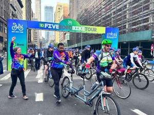 Legally blind biker Terrel Dobbins (in purple vest on back of tandem bike) was the stoker with pilot Marc Goldstein. Dobbins lost his sight in 2016 and said he had not ridden in 30 years before he began training for the 40-mile tour in March.