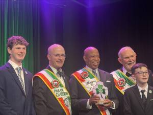 Mayor Eric Adams (center) shares the spotlight with the 2025 Grand Marshall Michael A. Benn (right of the mayor in photo ) and Parade chairman Sean Lane (left of mayor) and two of Benn’s 11 grandchildren at the annual St. Patrick’s Day Parade Foundation Dinner at the Marriott Marquis in midtown on March 12.