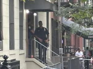 Police outside 440 West 47 Street Sept. 9 after a double stabbing left one man dead and a woman injured. A suspect who prosecutors said spent long stretches at that address was arrested the next day and charged with murder and attempted murder.