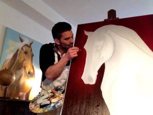 Erwan Saunier in his element, bringing a white horse to life on canvas