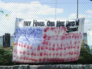A photo in one collection: “ ‘Many Hands. One Hope. United We Stand’ banner along the Hudson River.”