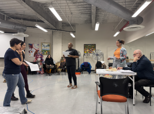 Director, Mino Lora, works through a scene with the cast of <i>Domino Effect.</i>