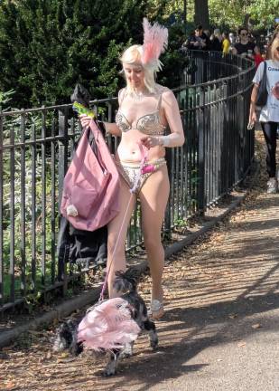 Pink feathers for a showgirl and her show dog on Avenue B at the 35th annual Tompkins Square Park Halloween Dog celebration.