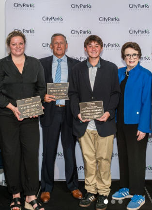Jayden Howard (center), a Stuyvesant High School student, received the Billie Jean King Tennis Junior Achievement Award at an annual City Parks Foundation fundraiser. Pictured alongside him (left to right): Kim Clijster, Peter Hurley and Billie Jean King.