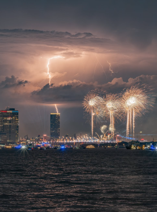 July 4th fireworks pictured from New Jersey, with a simultaneous lightning bolt.