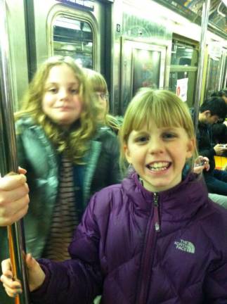 The author (front) during her grade school days on the subway. Photo courtesy of India Brown