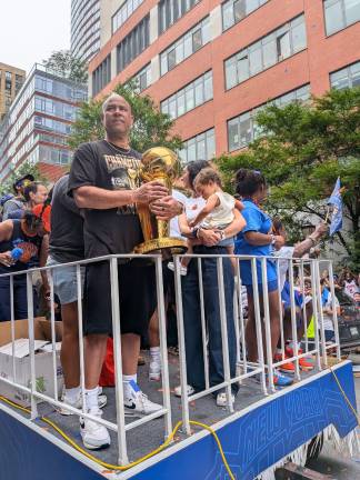 Knicks assistant Rick Brunson, Jalen’s dad, cradles the NBA Championship trophy at parade.