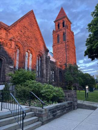 It’s almost sunset on a cloudy late-spring day in Buffalo’s Elmwood Village neighborhood. Here, the Lafayette Avenue Presbyterian Church provides a natural light show in a dramatic backdrop.