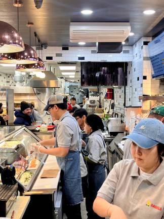Looking back from the pick-up area to the back of where the baking is done, the industrial green paint of the old bagel place is gone, now with artful tiling and a larger food prep area.