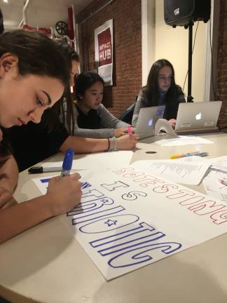 Members of Coalition Z, a political action group founded by three students from The Dalton School, made protest signs in opposition to cabinet appointments and executive orders that have defined the first weeks of President Donald Trump's tenure. Photo: Zoe Davidson