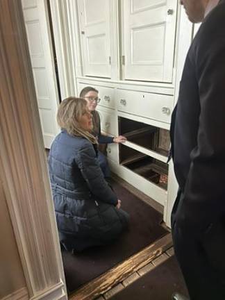 The bottom two drawers of the dresser are removed to expose the hidden passageway