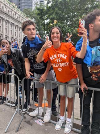 Knicks parade fan in New York vs. Everybody t-shirt and orange nail polish.
