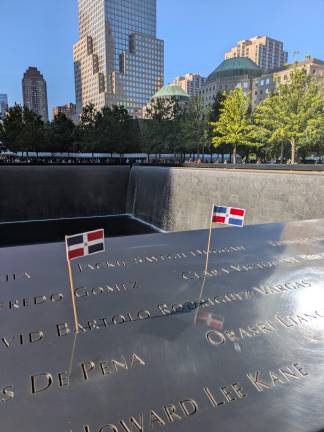 Dominican flags at the North Tower memorial pool for David Bartolo Rodriguez-Vargas, who died on 9/11.