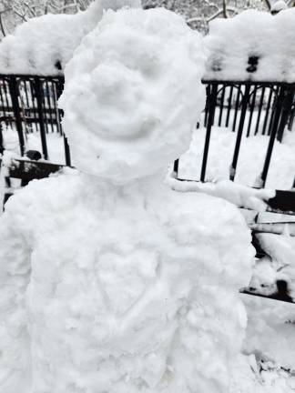 This snowman has heart, although not necessarily a warm one, outside Madison Square Park.