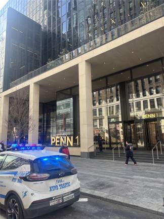 A police cruiser remains on the scene at One Penn Plaza on Feb. 25, less than 24 hours after a 26-year-old man plunged to his death from the tallest building in the Penn Plaza complex.