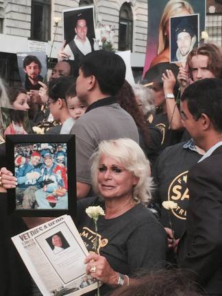 Denise Baum, foreground, holds a newspaper detailing the death of her husband, Rubin Baum, who was killed in 2012 on the Upper East Side. Photo: Logan Hendrix