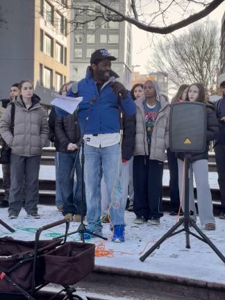 Chukwuma Obasi, parent of a student who completed eighth grade as the school was shutting down last June, addresses parents and former students before setting out for the school’s MLK march on Jan. 19th