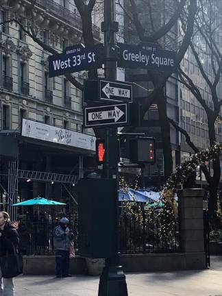 <b>In the video released for the Pogues’ “Fairy Tale of New York,” singer Kirsty MacColl was filmed walking forlornly in Greeley Square at the intersection of 6th Ave. and Broadway. It was one of many “on location” scenes shot for the black and white video.</b> Photo: Keith J. Kelly