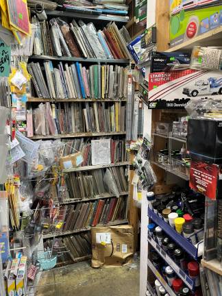 You are looking at the book section in the store, filled with new and used books about trains, both big and little, each encased in plastic covers to keep them in good order.